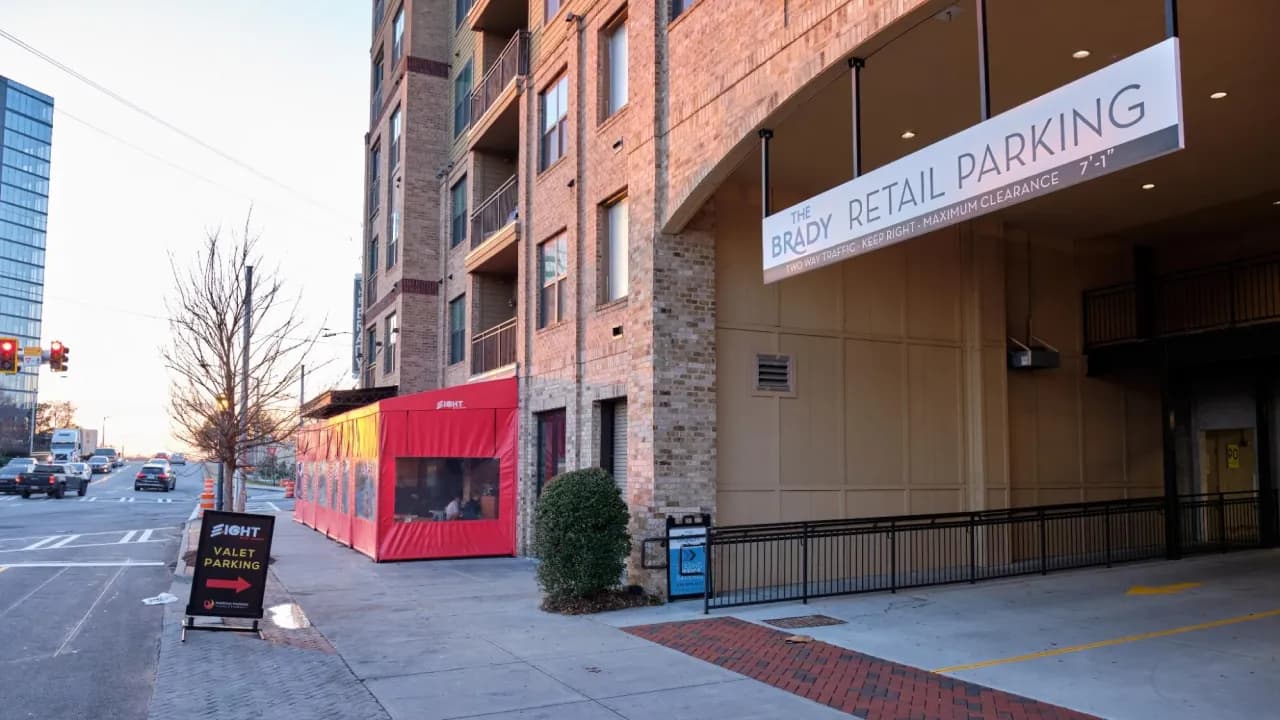 A valet parking area in front of restaurants.