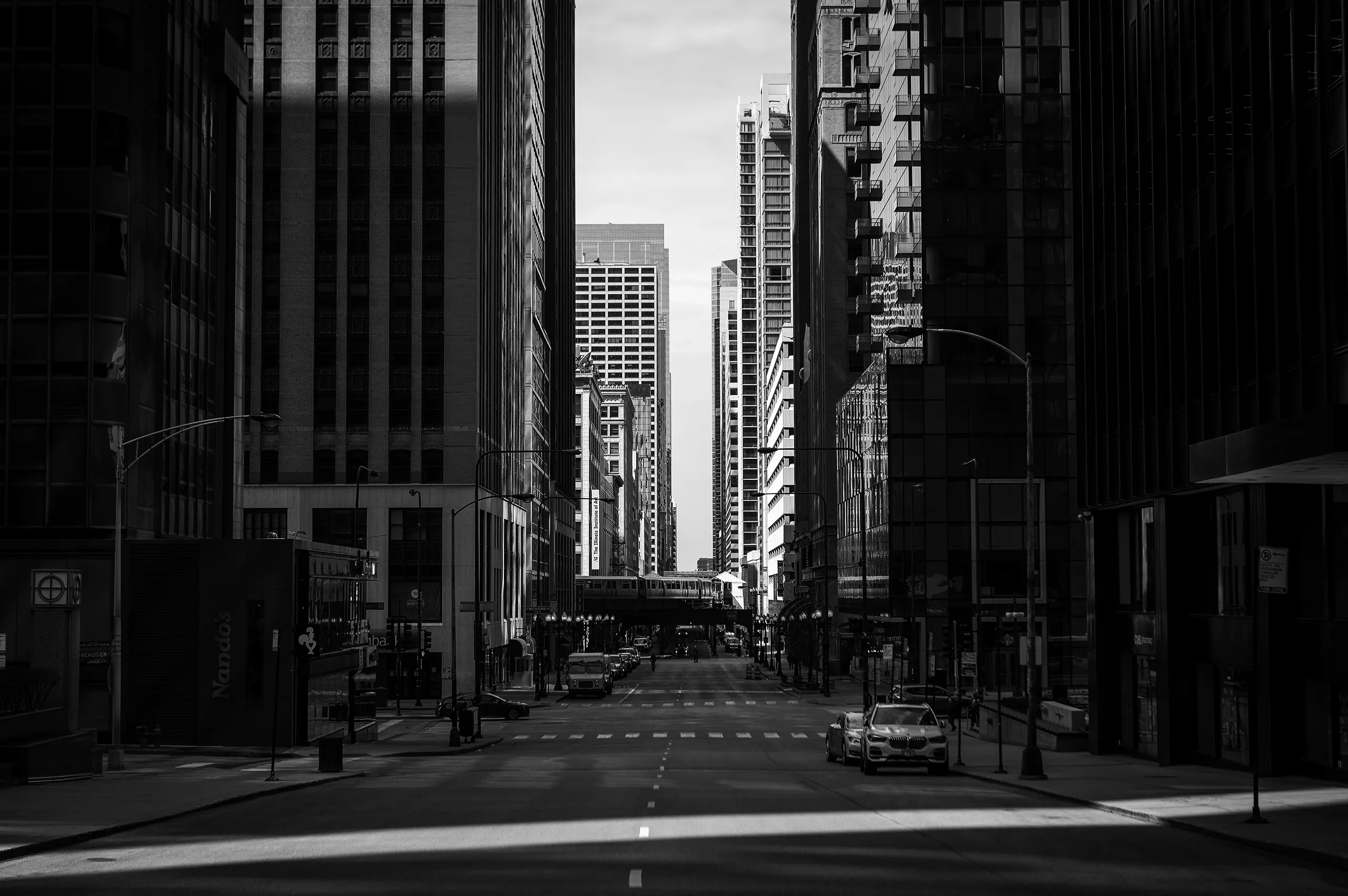 Hero image that is black and white of a bustling downtown area.