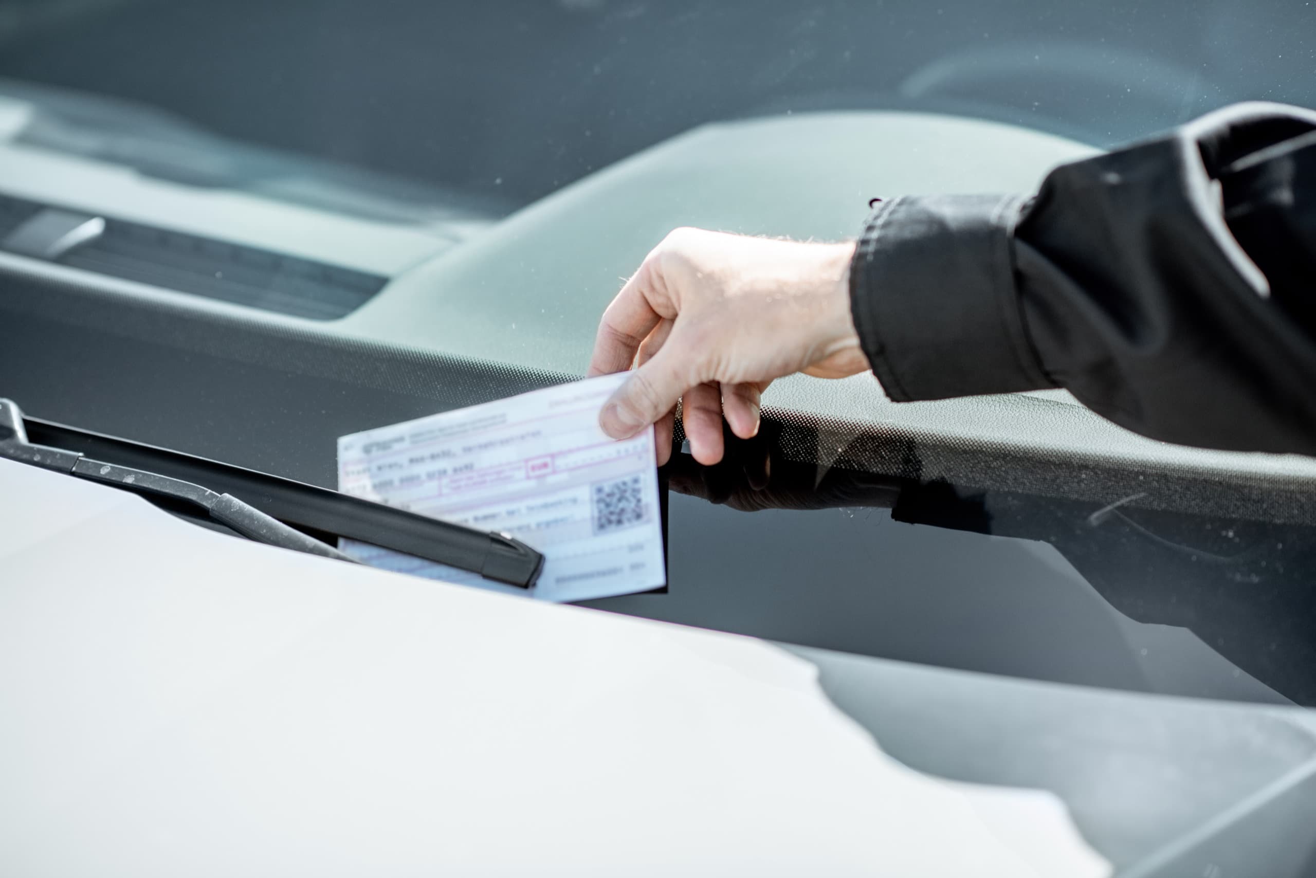 Parking ticket on a vehicle windshield.