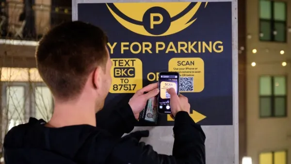 A person scanning a QR code for parking.