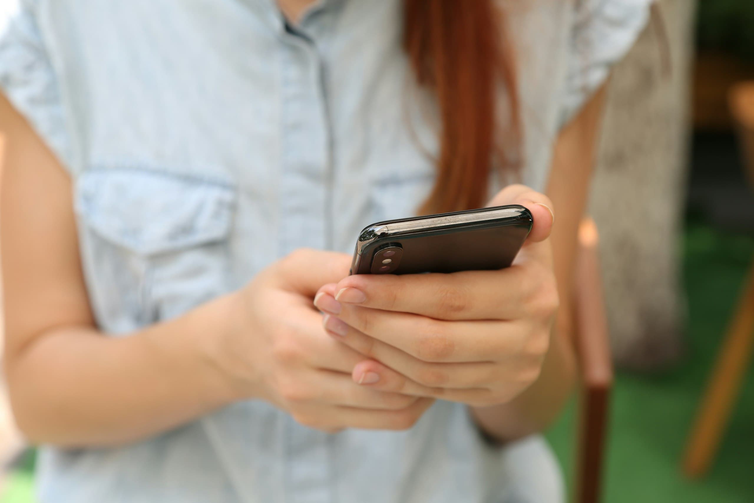 person holding using iPhone Xby Yura Fresh
