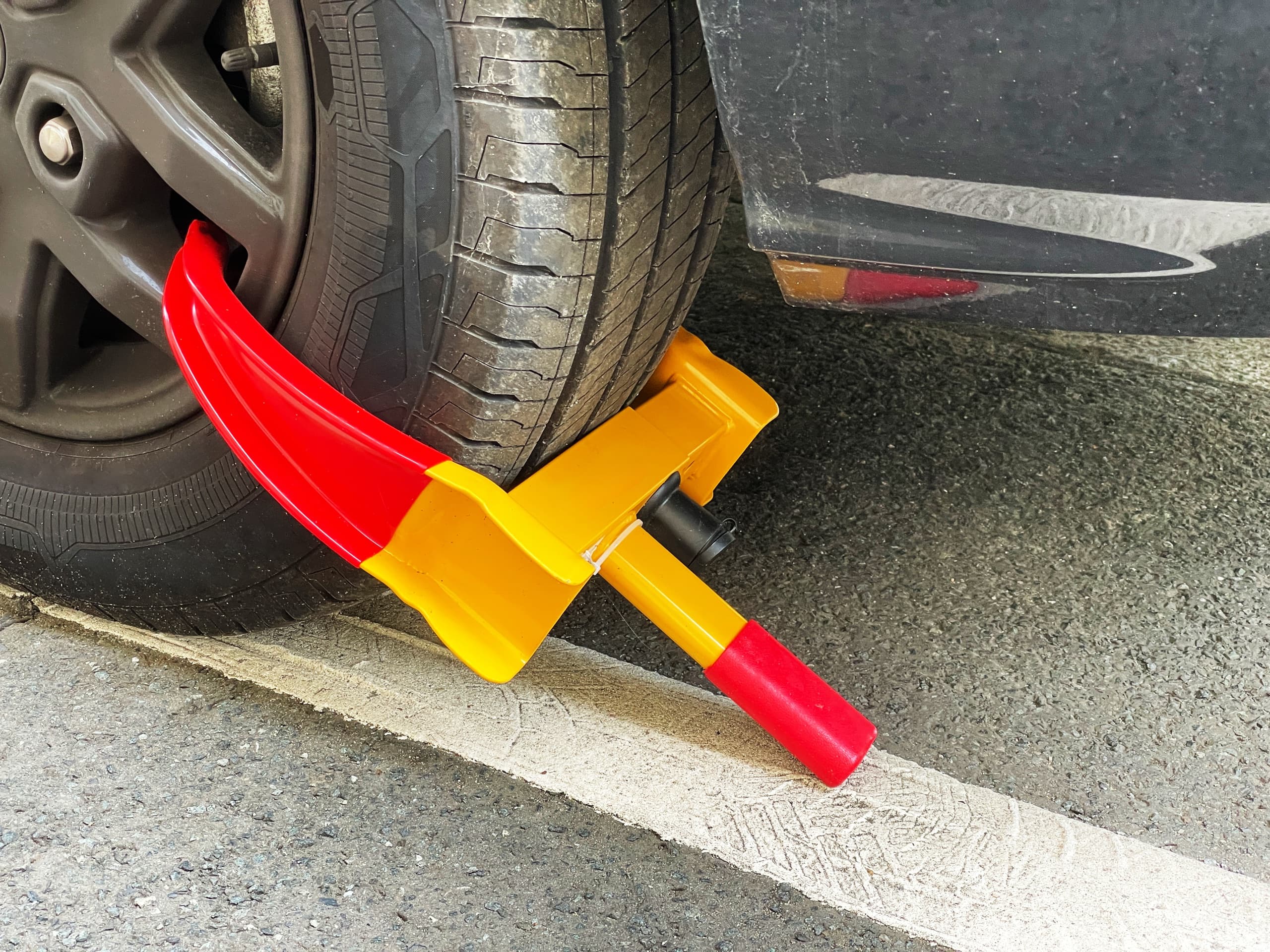 Parking enforcement wheel clamp on a vehicle.