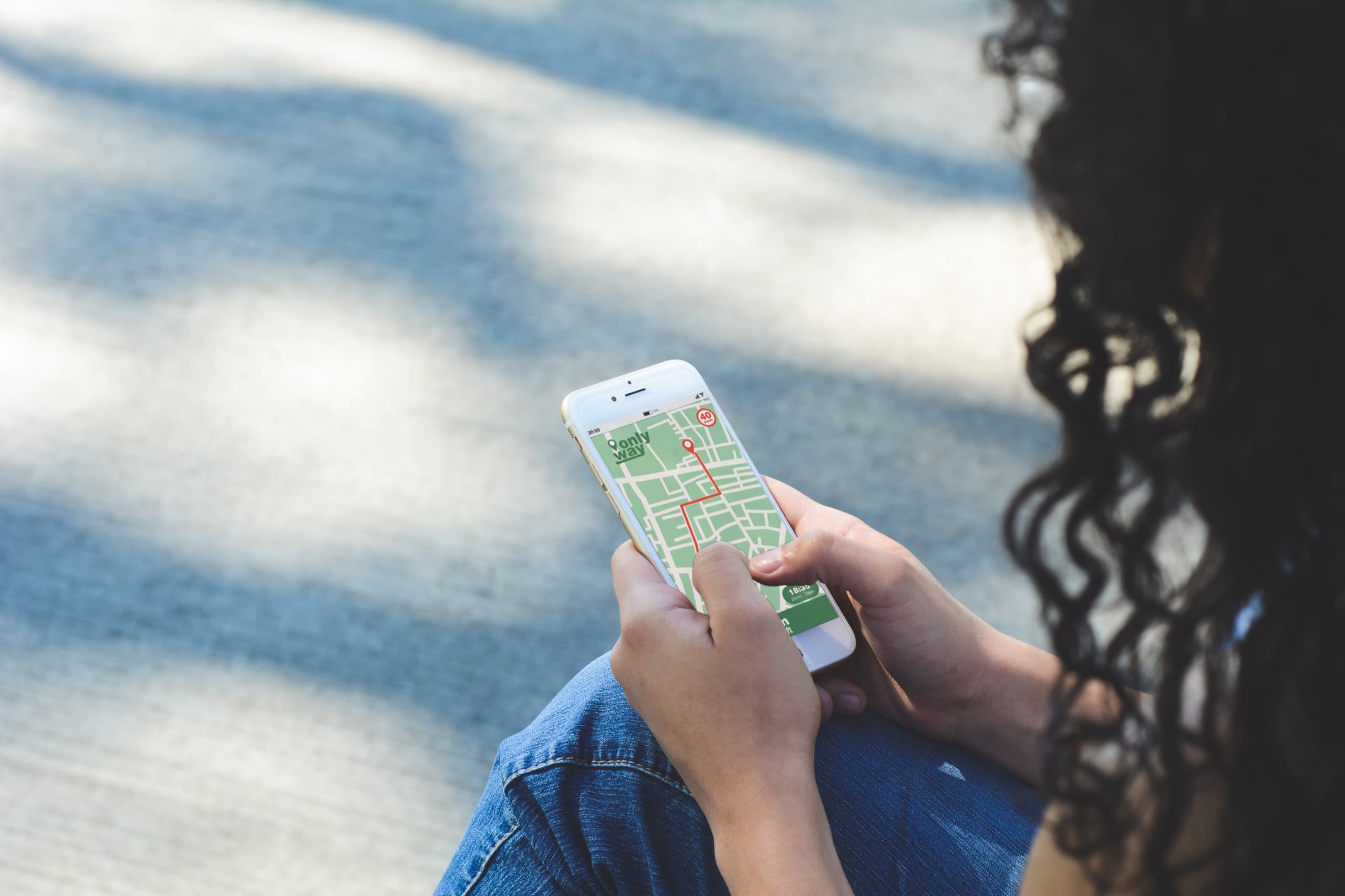 Driver using a navigation app to find parking.